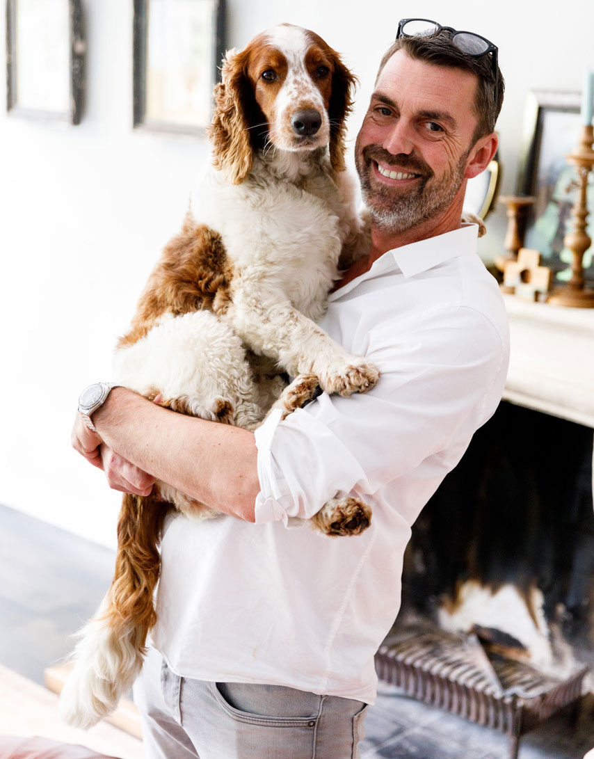Werner Nijenhuis, your host, holding Donna the spaniel in front of the fireplace