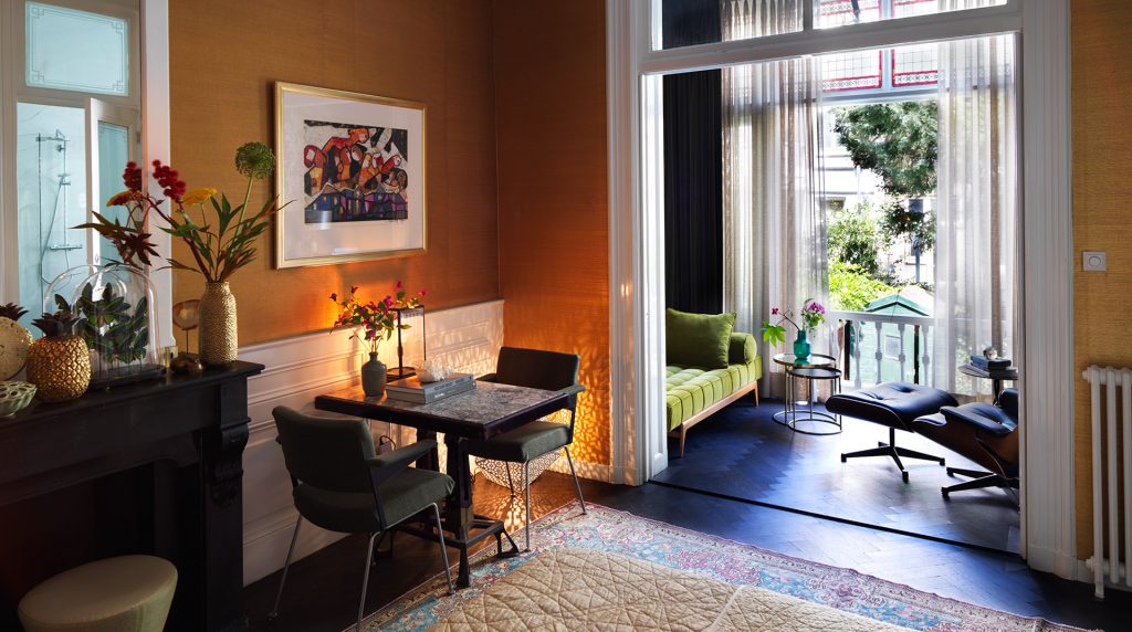 The Urban Suite lounge with warm walls and French doors to the garden